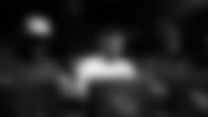 Teammates Zaven Collins (left) and Marvin Harrison Jr. (right) flank Mack Wilson Sr. during the "18 Bars" video shoot.