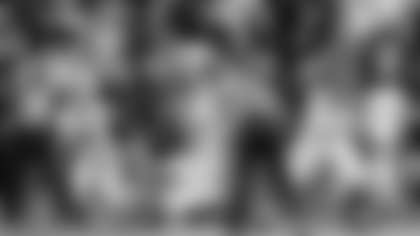 Alabama quarterback Bryce Young (9) scrambles from pressure during the second half of an NCAA college football game, Saturday, Nov. 27, 2021, in Auburn, Ala. Alabama running back Trey Sanders (6) and offensive lineman Javion Cohen (70) block Auburn linebacker Zakoby McClain (9) and defensive end Colby Wooden (25) on the play. (AP Photo/Vasha Hunt)