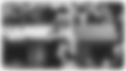 Quarterback Justin Herbert throws a 17-yard pass to running back Omarion Hampton.