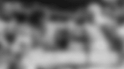 Green Bay Packers players enjoy turkey on the field in Detroit after their 31-24 win.