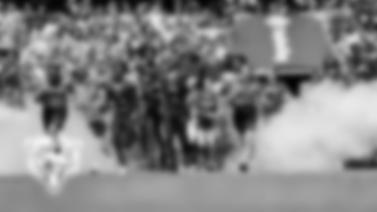 Youth football players leading the Bears onto the field