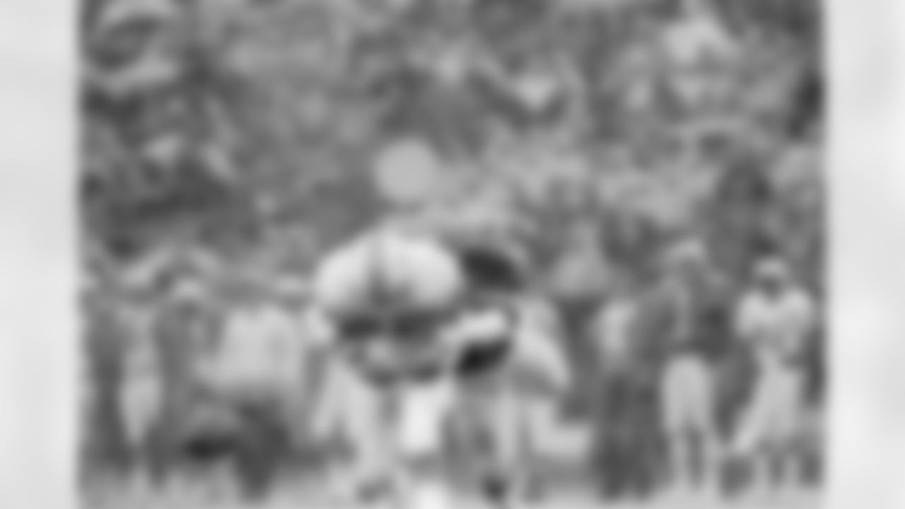 Miami Dolphins wide receiver Nat Moore has trouble holding on to the ball as he is pressured by Cincinnati Bengals linebacker Reggie Williams in driving rainstorm in the first half of a game in Cincinnati, Nov. 20, 1977. (AP Photo/Brian Horton)