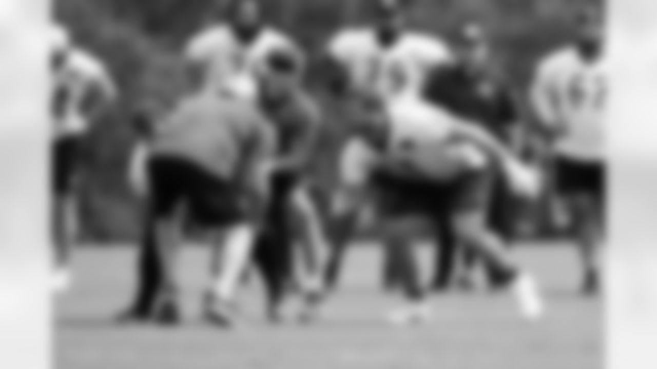 QB Joe Burrow takes a snap from C Ted Karras as G Cordell Volson blocks during phase two of offseason workouts at Kettering Health Practice Fields, Wednesday, May 7, 2025.