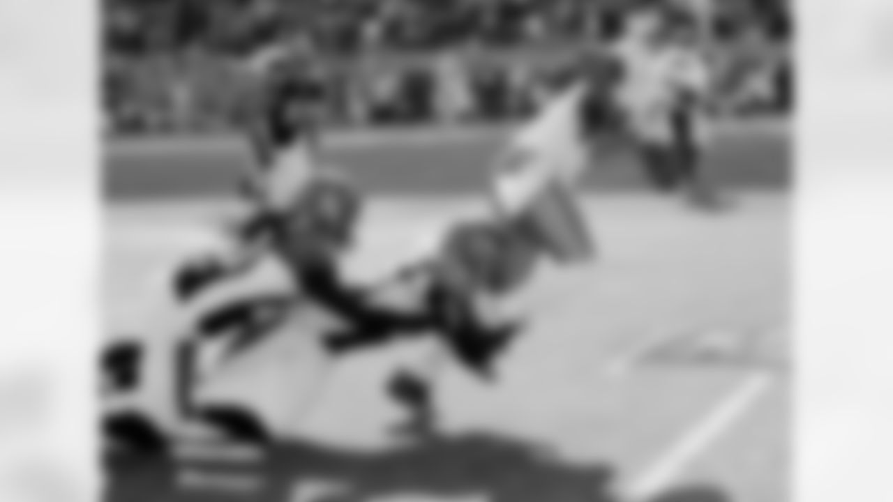 Miami Dolphins wide receiver Brandon Marshall (15) catches a pass and gets tackled by Cincinnati Bengals cornerback Morgan Trent (25) and Bengals safety Reggie Nelson (20) during the NFL week 8 football game against the Cincinnati Bengals on Sunday, October 31, 2010 in Cincinnati, Ohio. The Dolphins won the game 22-14. (AP Photo/Paul Spinelli)