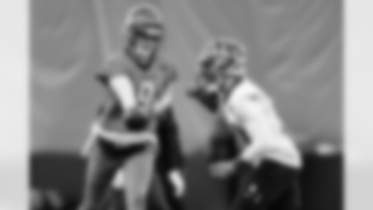 QB Joe Burrow hands the ball off to RB Chase Brown during practice at the IEL Indoor Facility, Wednesday, Dec. 10, 2025.