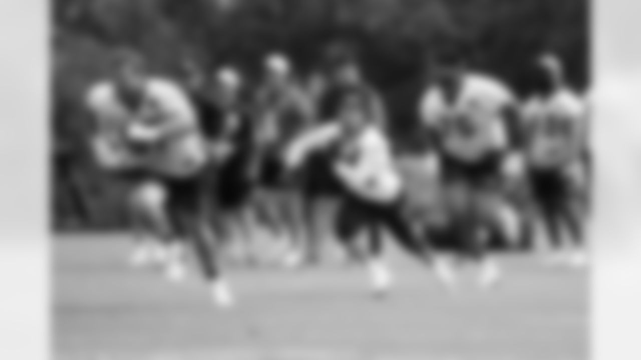 RB Chase Brown runs the ball as G Cordell Volson and OT Orlando Brown Jr. block during phase two of offseason workouts at Kettering Health Practice Fields, Wednesday, May 7, 2025.