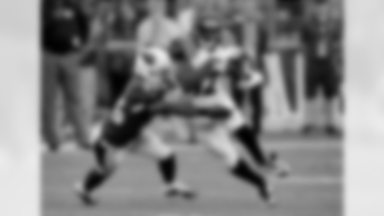 Cincinnati Bengals wide receiver Mohamed Sanu (12) runs after the catch as Arizona Cardinals cornerback Jerraud Powers (25) defends during the first half of an NFL preseason football game, Sunday, Aug. 24, 2014, in Glendale, Ariz. (AP Photo/Rick Scuteri)