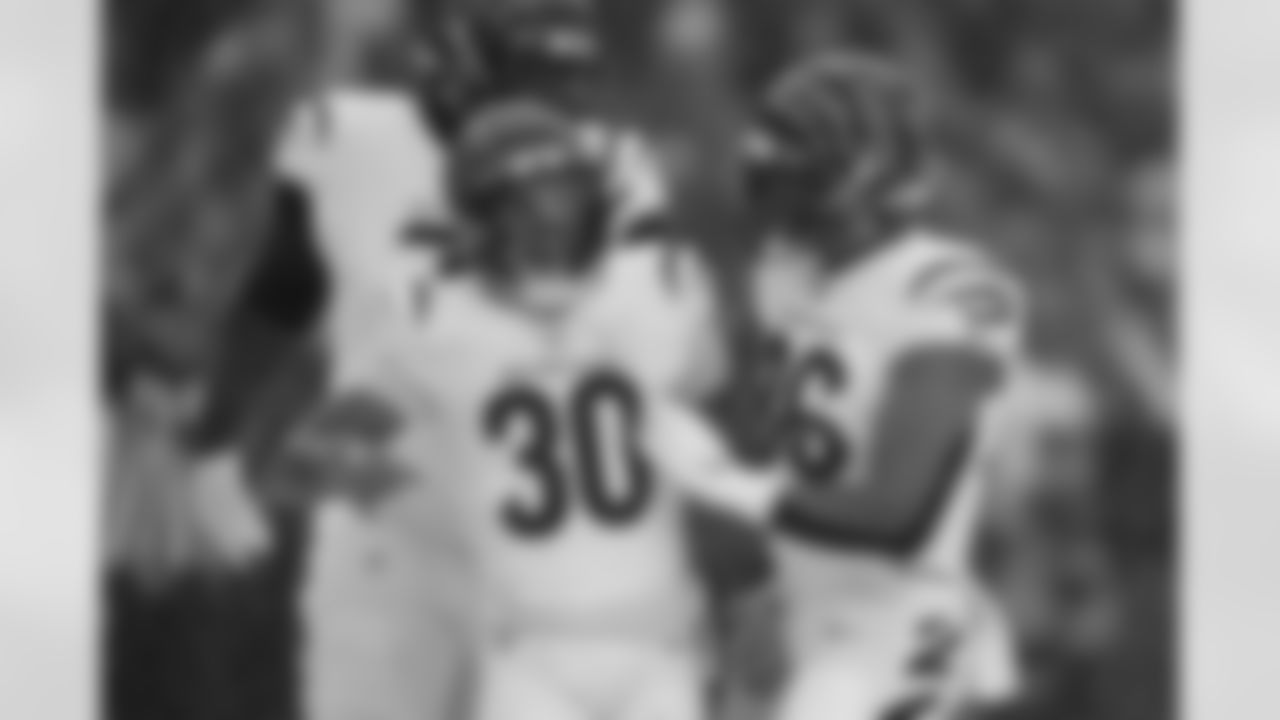 Cincinnati Bengals running back Chase Brown (30) celebrates scoring a touchdown with offensive tackle Amarius Mims (71) and tight end Noah Fant (86) during the first half of an NFL football game against the Buffalo Bills, Sunday, Dec. 7, 2025, in Orchard Park, N.Y.