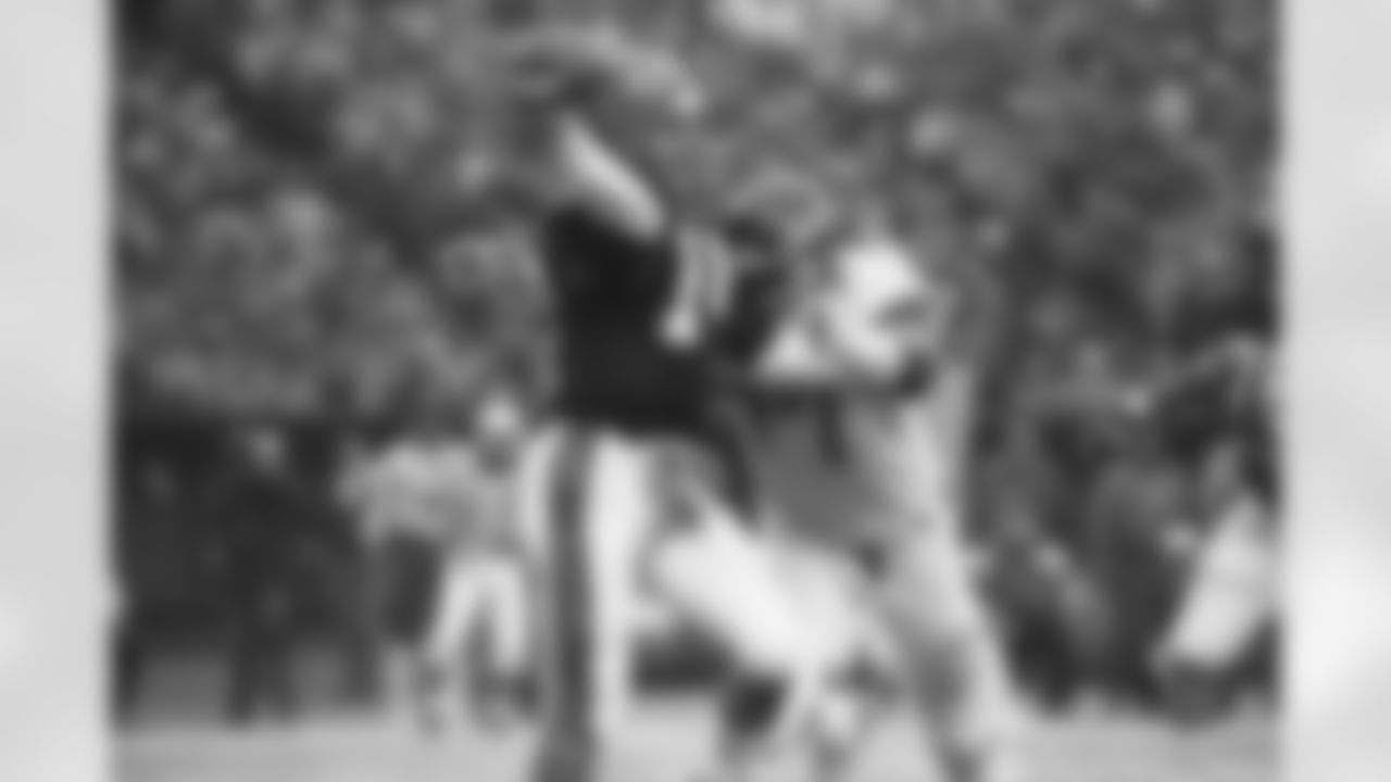 Cincinnati Bengals quarterback Ken Anderson, (14) releases the ball as New York Jets' Kenny Neil (77) reaches him in Sunday playoff action in Cincinnati, Ohio, Jan. 10, 1983.