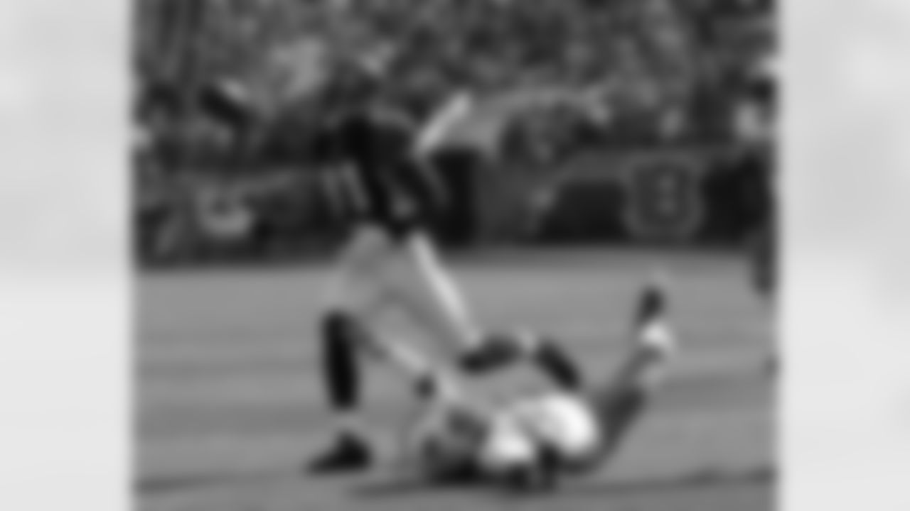 Cincinnati Bengals wide receiver Terrell Owens (81) catches a touchdown pass that was tipped by Miami Dolphins safety Chris Clemons (30) in the first half of an NFL football game, Sunday, Oct. 31, 2010, in Cincinnati. (AP Photo/Ed Reinke)