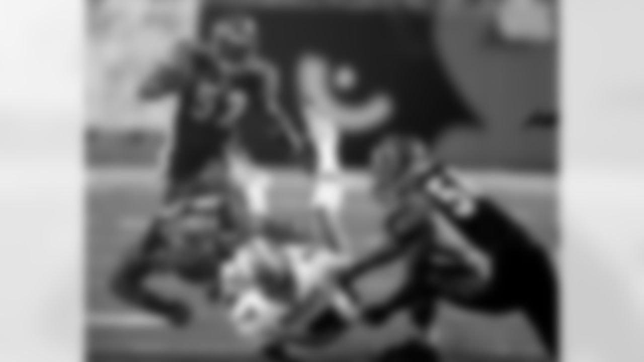 Carl Powell #72 and Brian Simmons #56 of the Cincinnati Bengals sack A.J. Feeley #7 of the Miami Dolphins during an NFL football game on Sept. 19, 2004 in Cincinnati. The Bengals defeated the Dolphins 16-13. (Joe Robbins via AP)