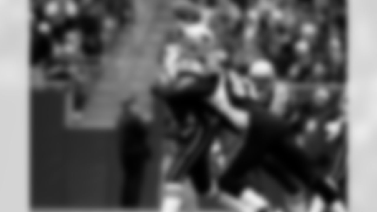 Tom Brady #12 of the New England Patriots gets hit as he throws by Duane Clemons #92 of the Cincinnati Bengals during an NFL football game on Dec. 12, 2004 in Foxborough, Mass. The Patriots defeated the Bengals 35-28. (Joe Robbins via AP)