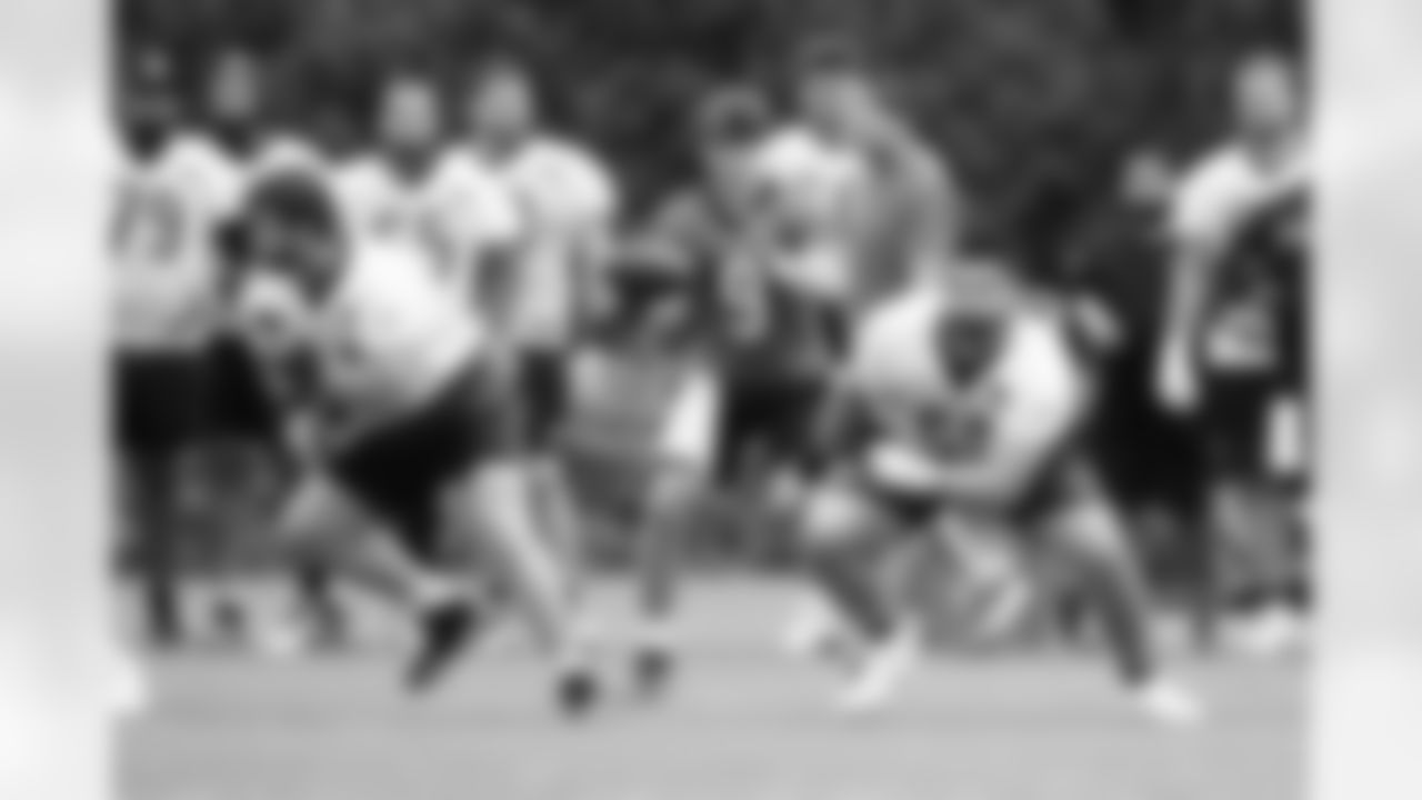 QB Joe Burrow takes the snap from C Ted Karras while G Dylan Fairchild blocks during Phase Two of offseason workouts at Kettering Health Practice Fields, Tuesday, May 13, 2025.