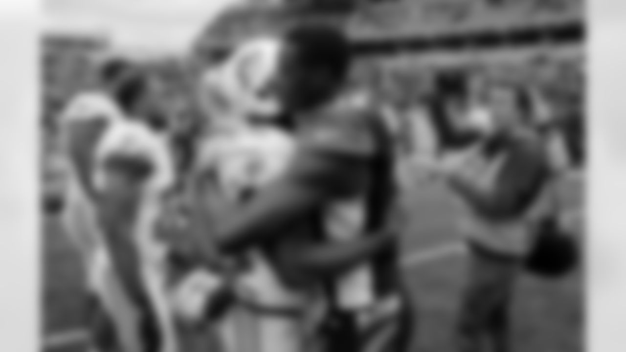 Cincinnati Bengals wide receiver A.J. Green (18) hugs Miami Dolphins running back Reggie Bush (22) after the Dolphins defeated the Bengals 17-13 in an NFL football game, Sunday, Oct. 7, 2012, in Cincinnati. (AP Photo/Tom Uhlman)