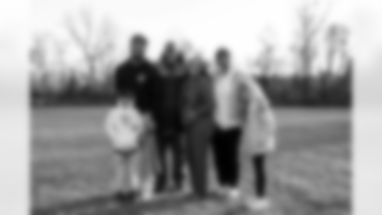 Christian Benford poses for a family photo after his son's baseball practice, April 08, 2025 in Owens Mills.
