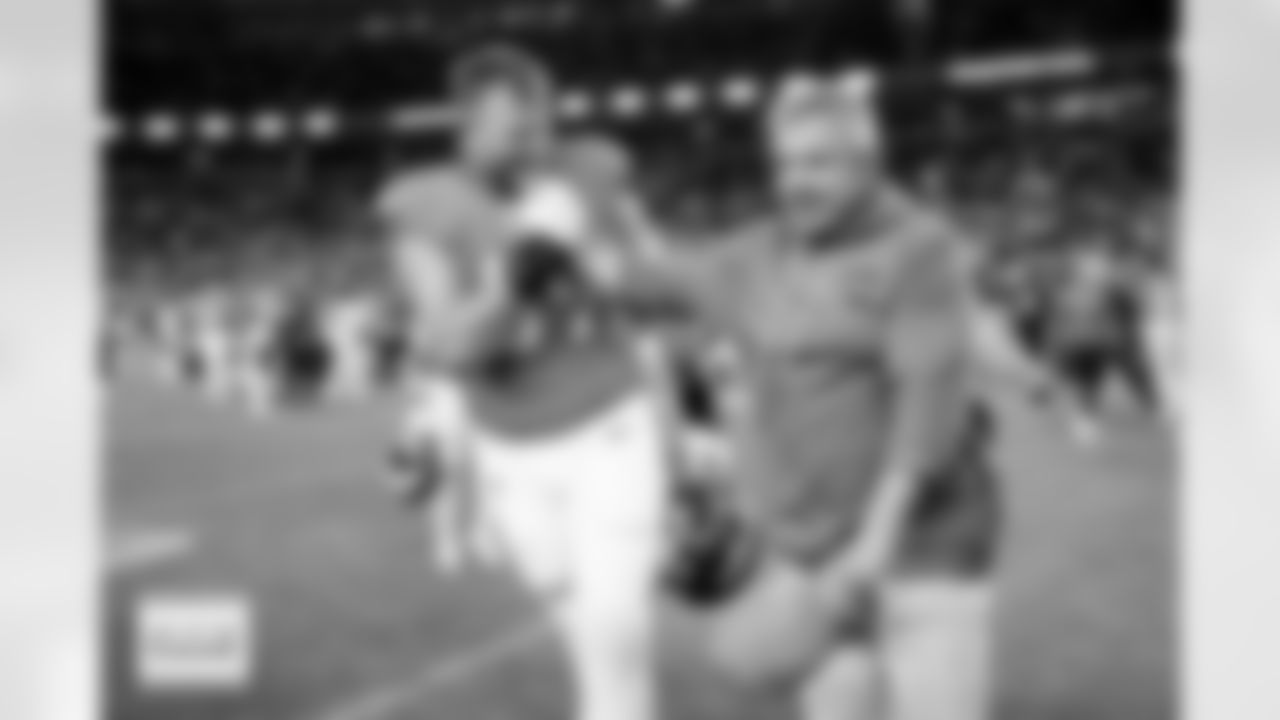 Denver Broncos offensive tackle Mike McGlinchey (69) and head coach Sean Payton celebrate after the Broncos' Week 11 game against the Kansas City Chiefs at Empower Field at Mile High in Denver, Colorado on November 16, 2025. Photo by Ben Swanson / Denver Broncos