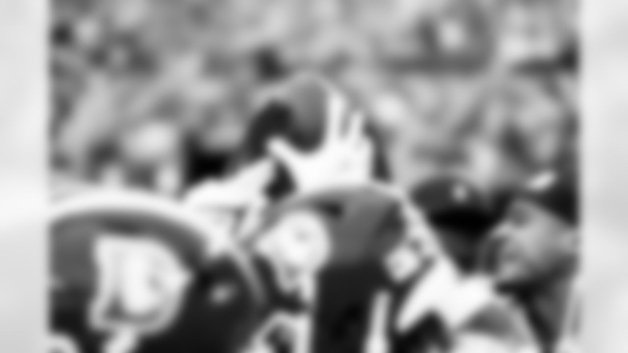 The defensive backs hold a ball up in a huddle before the Broncos' Week 8 game against the Dallas Cowboys at Empower Field at Mile High in Denver, Colorado on October 26, 2025. Photo by Gabriel Christus / Denver Broncos