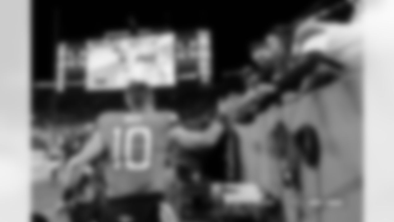 Denver Broncos quarterback Bo Nix (10) high-fives fans after the Broncos' Week 15 game against the Indianapolis Colts at Empower Field at Mile High in Denver, Colorado on December 15, 2024. Photo by Nicole Pennetta / Denver Broncos