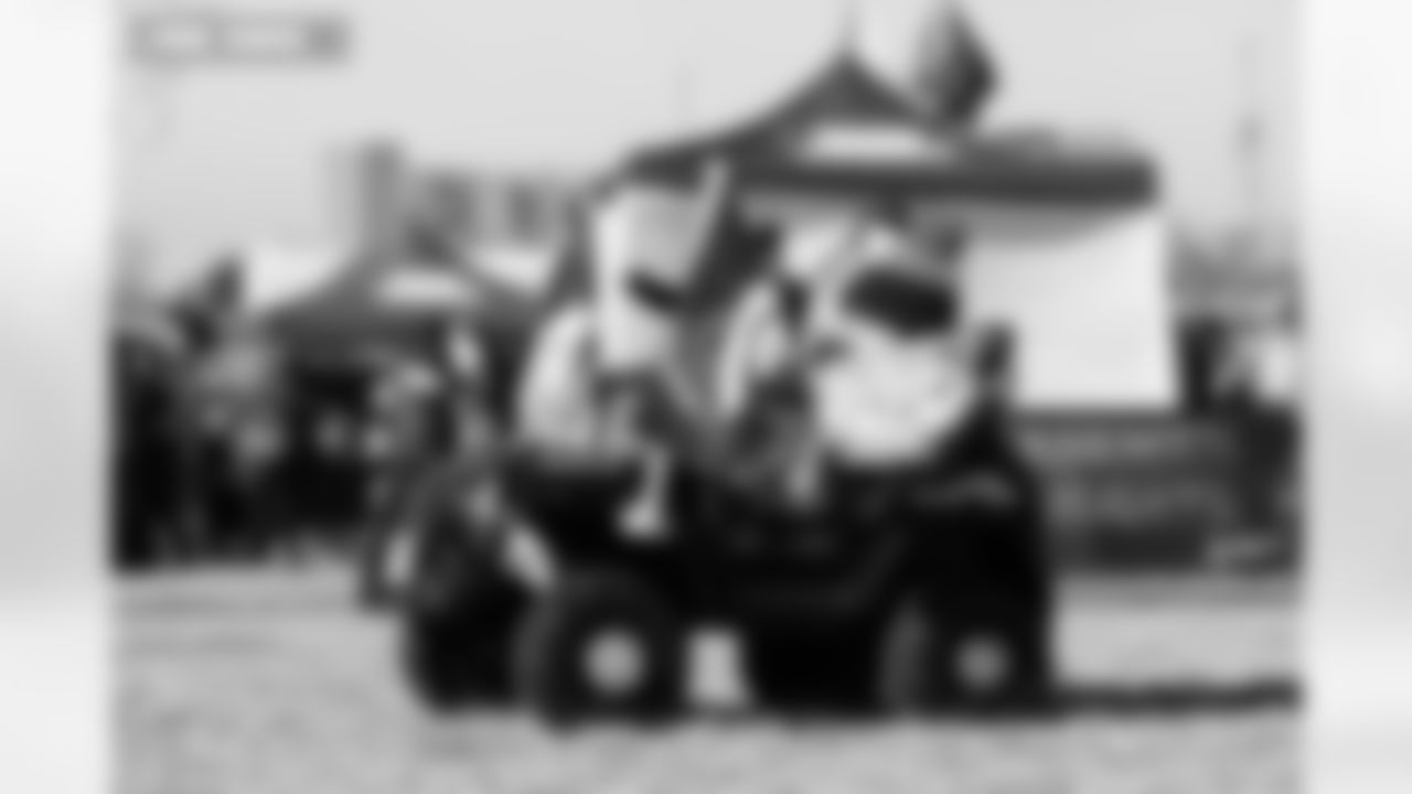 A father drives his kid around the tailgate in an rc car before the AFC Championship Game between the Denver Broncos and New England Patriots at Empower Field at Mile High in Denver, Colorado on January 25, 2026. Photo by Gavin Liddell / Denver Broncos