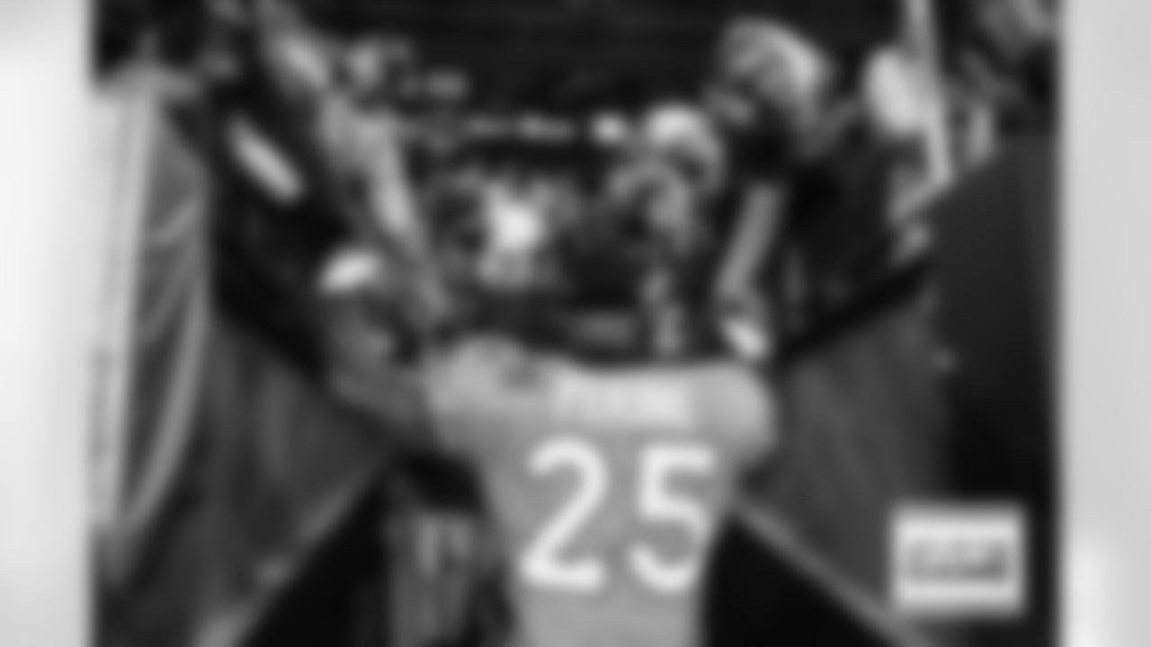 Denver Broncos running back Samaje Perine (25) high-fives fans as he goes into the locker room after the Broncos' Week 12 game against the Cleveland Browns at Empower Field at Mile High in Denver, Colorado on November 26, 2023. Photo by Rachel O'Driscoll / Denver Broncos