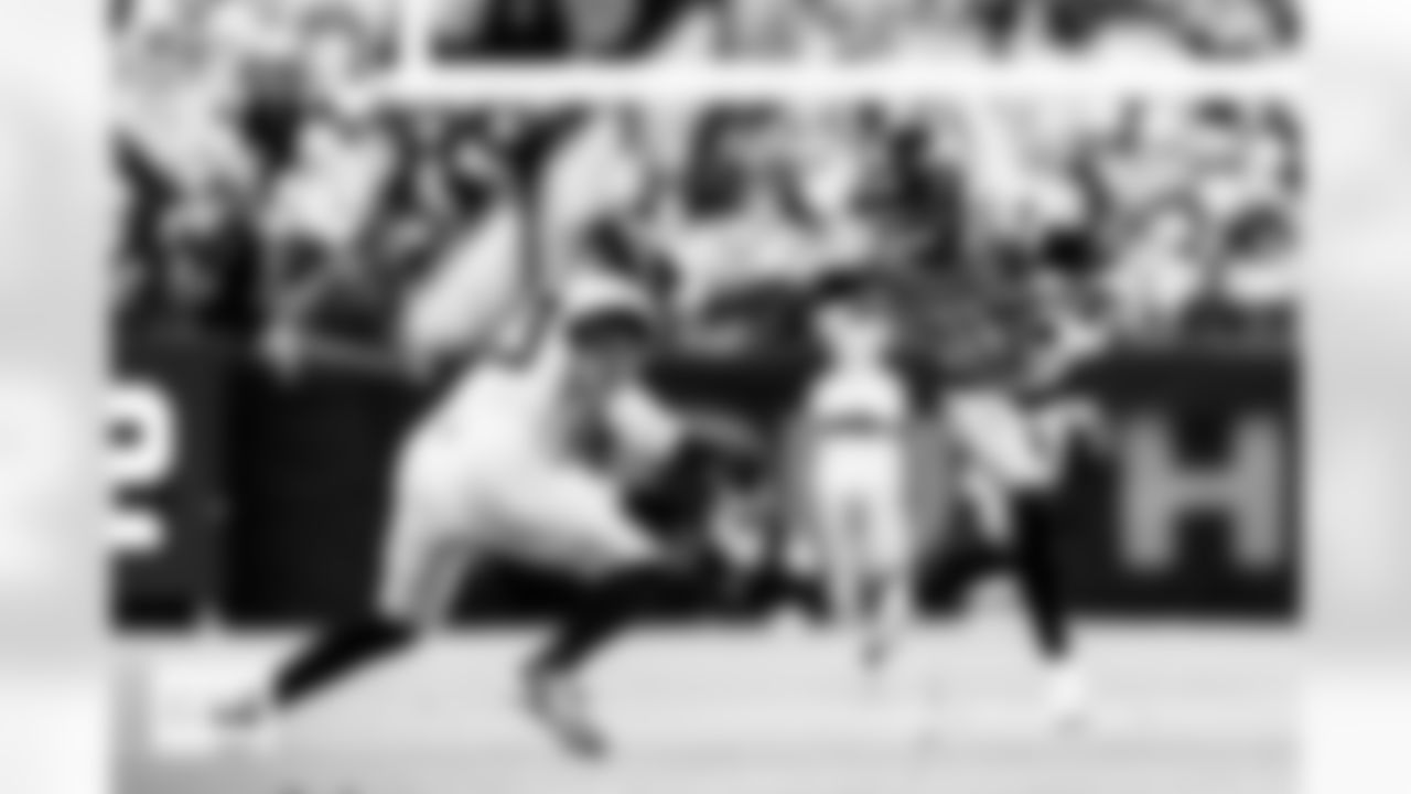 Denver Broncos wide receiver Troy Franklin (11) runs with the ball on a reception and stiff-arms Jacksonville Jaguars linebacker Foyesade Oluokun (23) during the Broncos' Week 16 game against the Jacksonville Jaguars at Empower Field at Mile High in Denver, Colorado on December 21, 2025. Photo by Ben Swanson / Denver Broncos