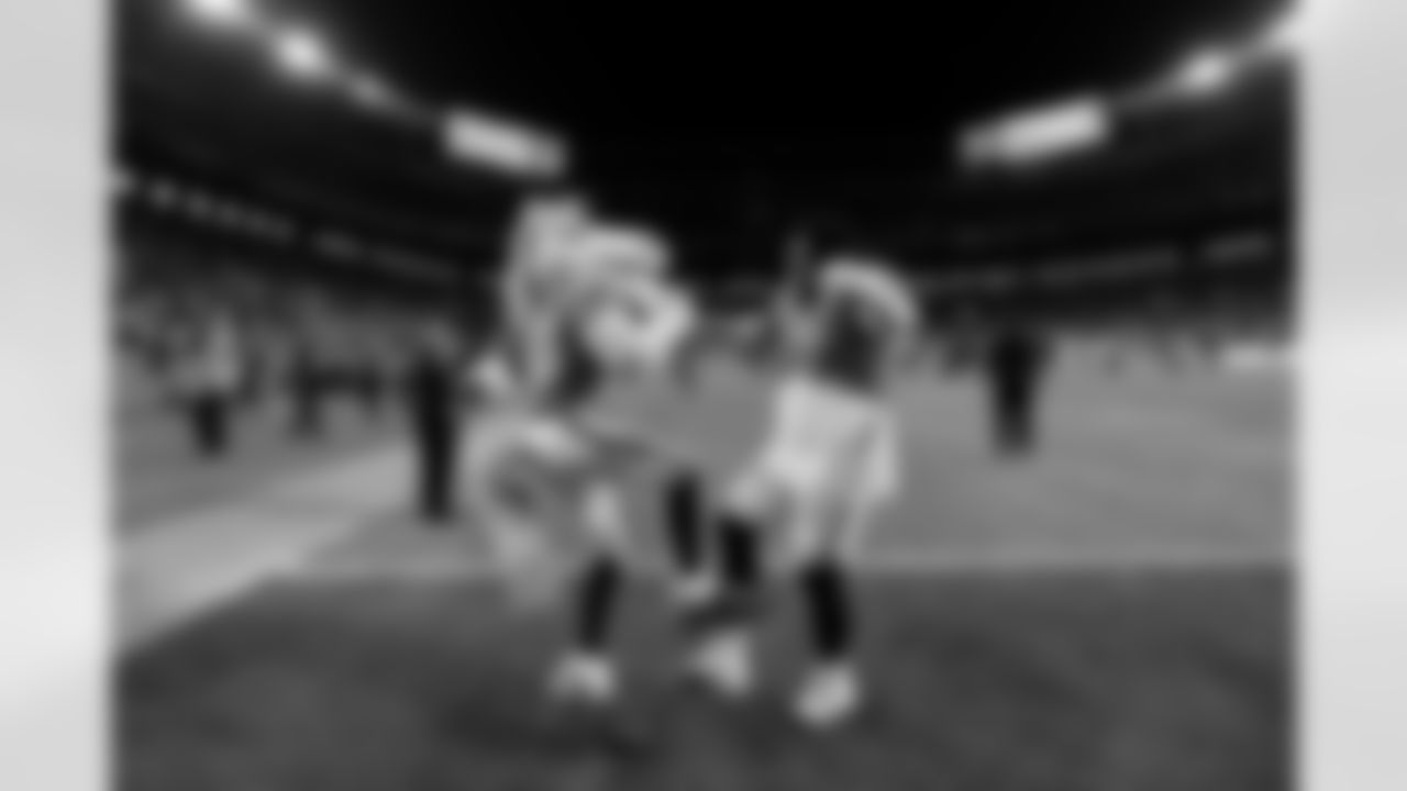 Denver Broncos defensive tackle Malcolm Roach (97) dances with Miles the Mascot after the Broncos' Week 15 game against the Green Bay Packers at Empower Field at Mile High in Denver, Colorado on December 14, 2025. Photo by Ben Swanson / Denver Broncos