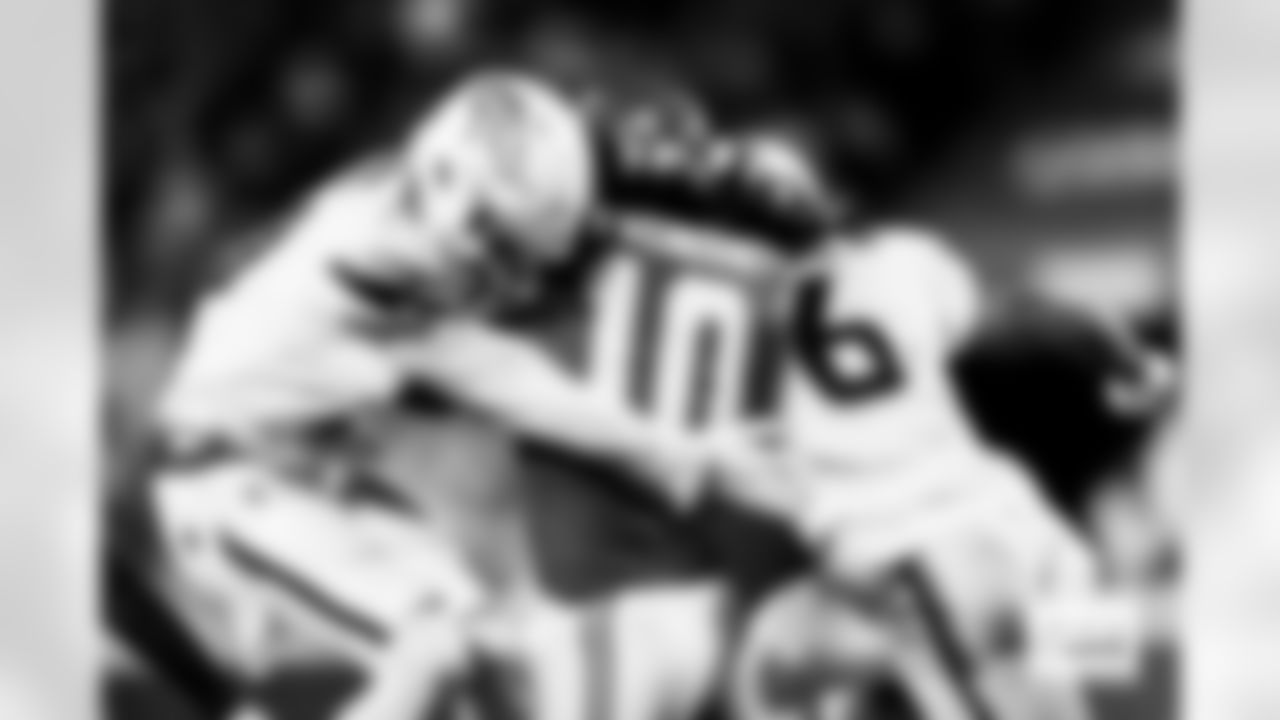 Denver Broncos cornerback Riley Moss (21) and safety P.J. Locke (6) tackle Kansas City Chiefs running back Isiah Pacheco (10) during the Broncos' Week 17 game against the Kansas City Chiefs at GEHA Field at Arrowhead Stadium in Kansas City, Missouri on December 25, 2025. Photo by Gabriel Christus / Denver Broncos