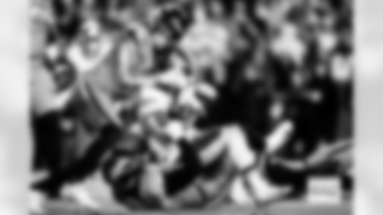 Denver Broncos safety Talanoa Hufanga (9) and linebacker Jonathon Cooper (0) tackle Washington Commanders running back Jacory Croskey-Merritt (22) during the Broncos' Week 13 game against the Washington Commanders at Northwest Stadium in Landover, Maryland on November 30, 2025. Photo by Ben Swanson / Denver Broncos