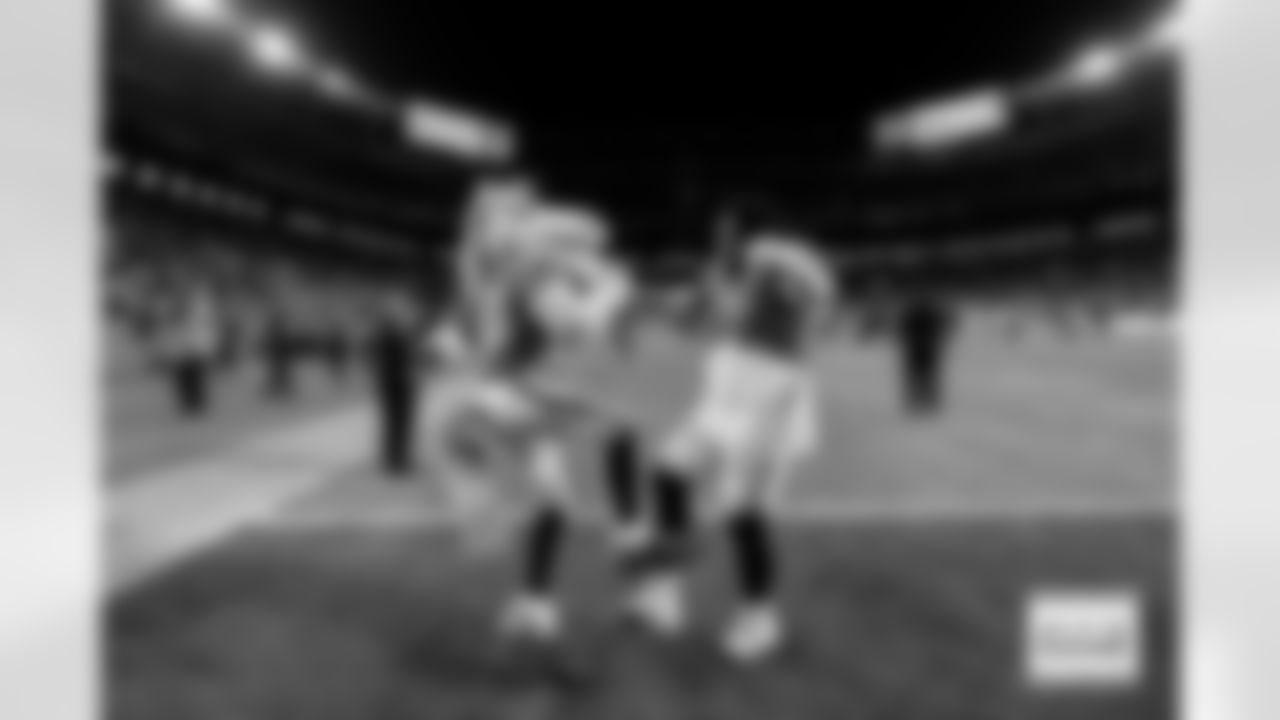 Denver Broncos defensive tackle Malcolm Roach (97) dances with Miles the Mascot after the Broncos' Week 15 game against the Green Bay Packers at Empower Field at Mile High in Denver, Colorado on December 14, 2025. Photo by Ben Swanson / Denver Broncos