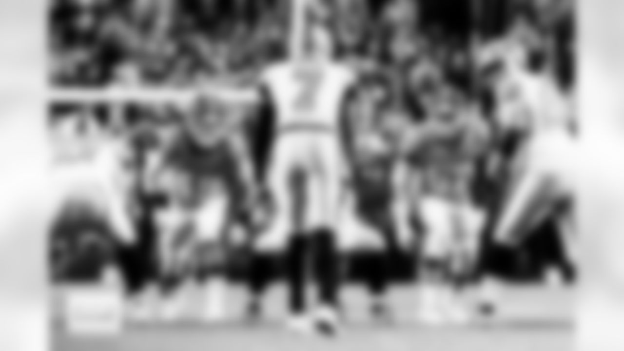 Denver Broncos linebackers Alex Singleton (49) and Dre Greenlaw (57) stare across the line at Raiders quarterback Geno Smith during the Broncos' Week 10 game against the Las Vegas Raiders at Empower Field at Mile High in Denver, Colorado on November 6, 2025. Photo by Gavin Liddell / Denver Broncos