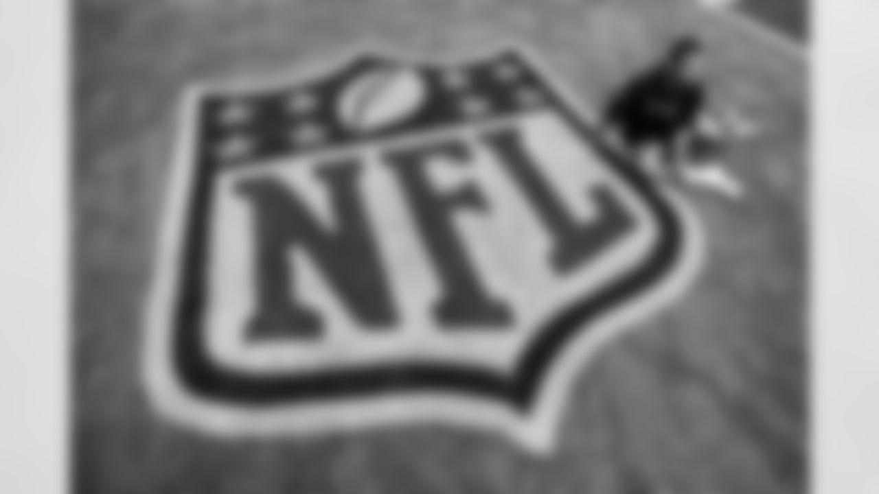 Pat Surtain II stretches next to the NFL shield logo before the Broncos' Week 4 game against the Chicago Bears at Soldier Field in Chicago, Illinois on October 1, 2023. Photo by Ben Swanson / Denver Broncos