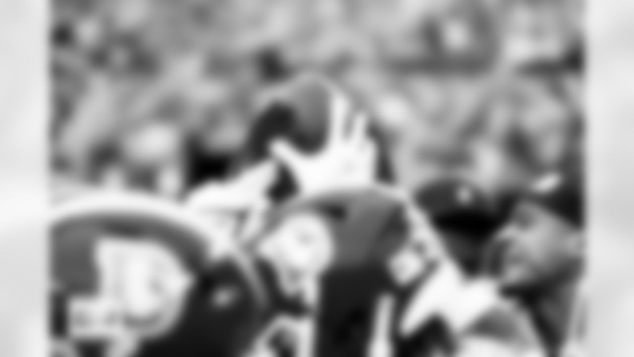 The defensive backs hold a ball up in a huddle before the Broncos' Week 8 game against the Dallas Cowboys at Empower Field at Mile High in Denver, Colorado on October 26, 2025. Photo by Gabriel Christus / Denver Broncos