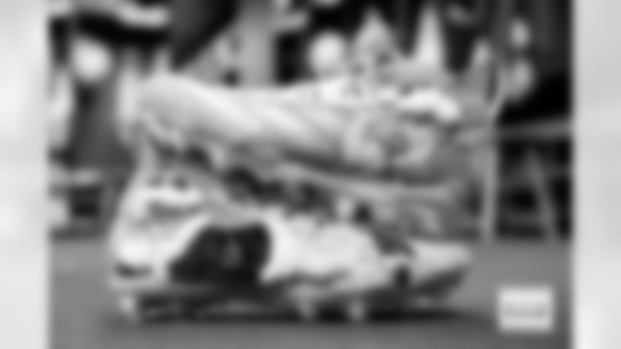 Marcedes Lewis's Grinch themed cleats in the locker room before the Broncos' Week 17 game against the Kansas City Chiefs at GEHA Field at Arrowhead Stadium in Kansas City, Missouri on December 25, 2025. Photo by Gabriel Christus / Denver Broncos