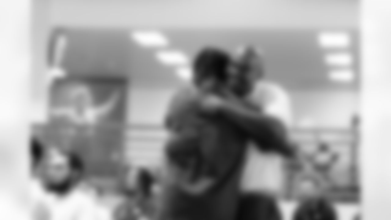 Inmates hug during a visit to the Arkansas Valley Correctional Facility in Ordway, Colorado on October 14, 2025. In partnership with the Vera Institute of Justice, the Denver Broncos Foundation toured ChangeMakers Village (a Restoring Promise Unit).Photo by Gabriel Christus / Denver Broncos