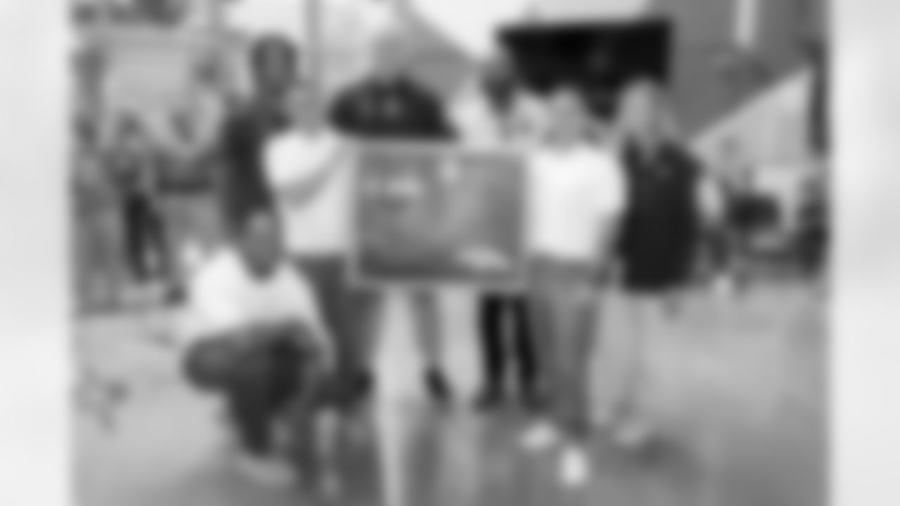 Changemakers pose with Garett Bolles, Jurrell Casey, Pat Bryant and Carrie Walton Penner during a visit to the Arkansas Valley Correctional Facility in Ordway, Colorado on October 14, 2025. In partnership with the Vera Institute of Justice, the Denver Broncos Foundation toured ChangeMakers Village (a Restoring Promise Unit).Photo by Gabriel Christus / Denver Broncos