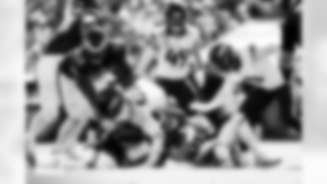 Denver Broncos safety Talanoa Hufanga (9) and defensive end John Franklin-Myers (98) make a tackle during the Broncos' Week 5 game against the Philadelphia Eagles at Lincoln Financial Field in Philadelphia, Pennsylvania on October 5, 2025. Photo by Gabriel Christus / Denver Broncos