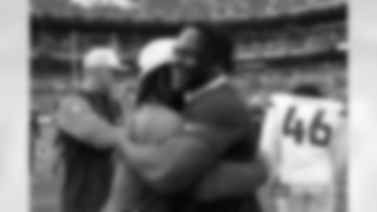 Former college teammates Michael Carter and Javonte Williams hug after the Broncos' Preseason Week 3 game against the Arizona Cardinals at Empower Field At Mile High on August 25, 2024 in Denver, Colorado. (Photo by Ben Swanson/Denver Broncos)