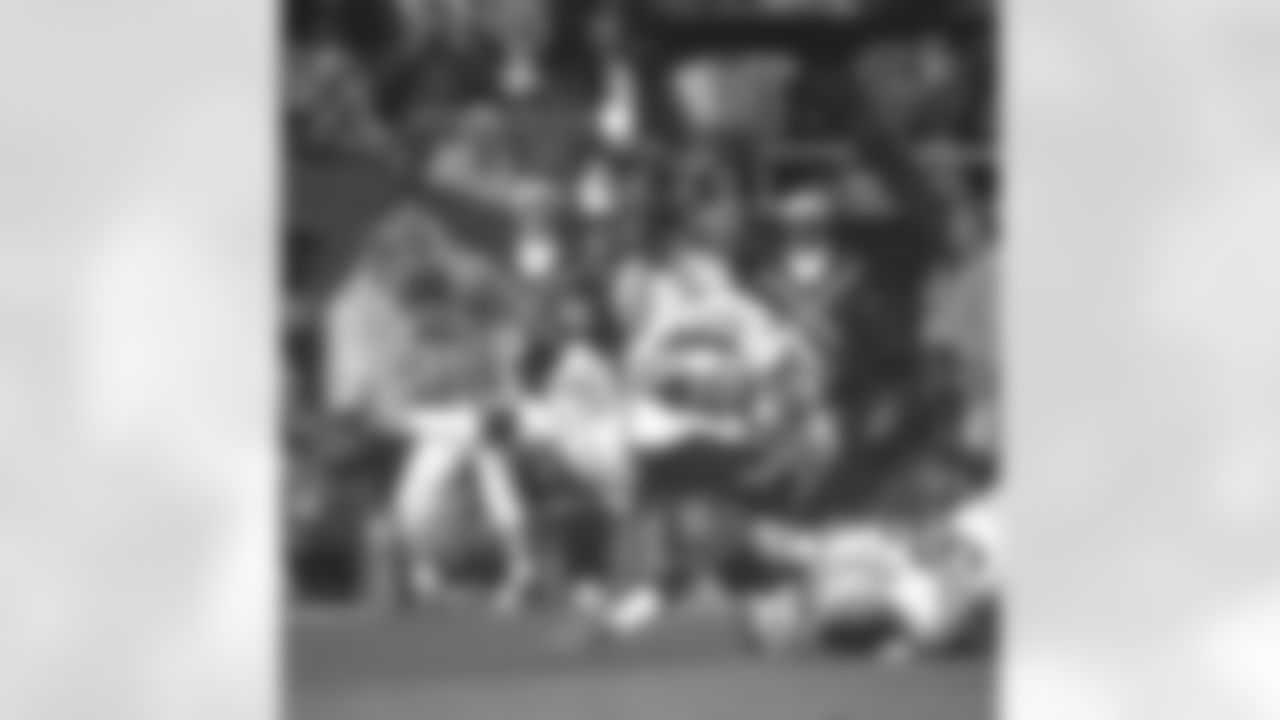 John Elway scrambles with the ball in the third quarter on a crucial third-down play and gains the first down in Super Bowl XXXII against the Packers. The diving attempt and 180-degree spin was a pivotal moment, now known as "The Helicopter, showing Elway's desire to risk everything for the win at Qualcomm Stadium in San Diego, CA on January 25, 1998.