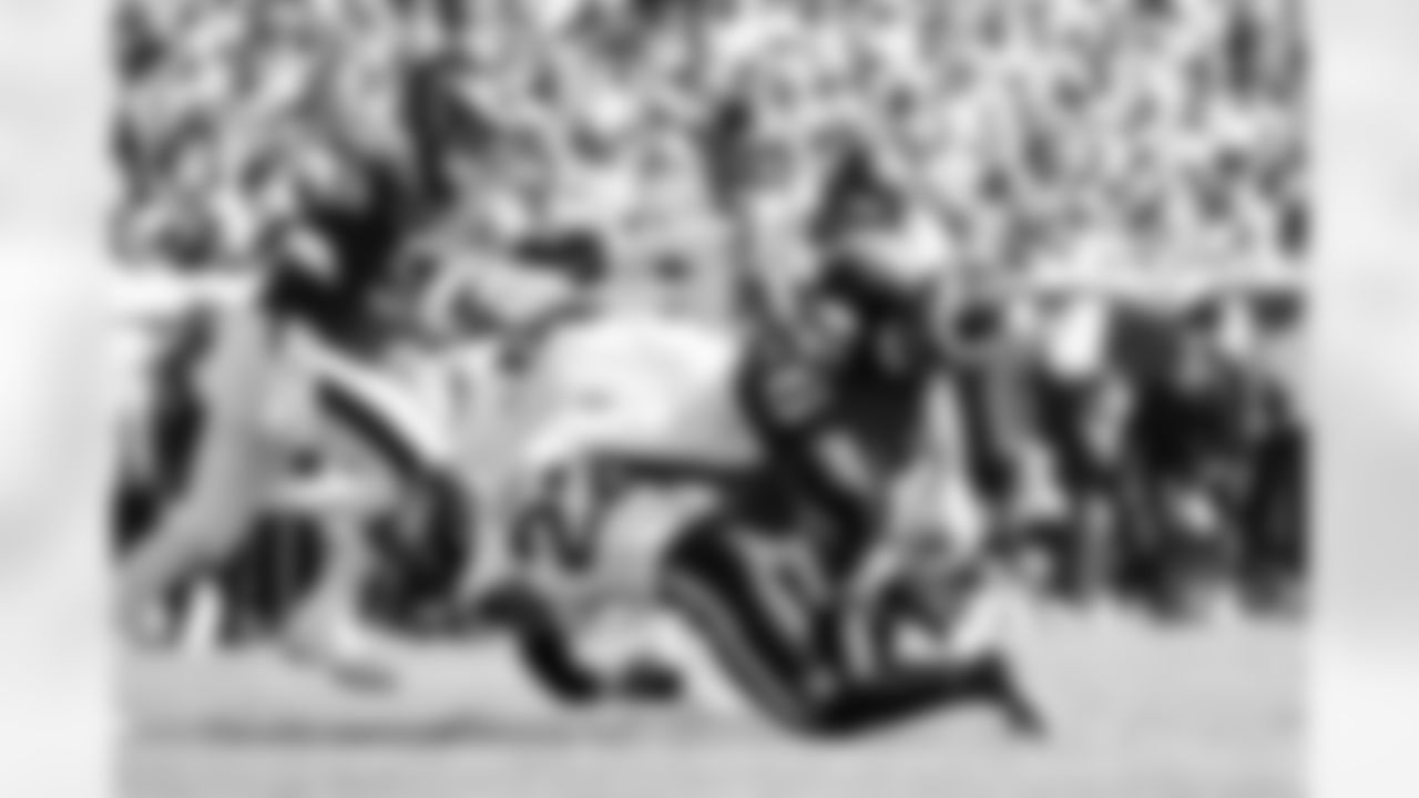 Denver Broncos safety Brandon Jones (22) tackles Philadelphia Eagles running back Saquon Barkley (26) during the Broncos' Week 5 game against the Philadelphia Eagles at Lincoln Financial Field in Philadelphia, Pennsylvania on October 5, 2025. Photo by Ben Swanson / Denver Broncos