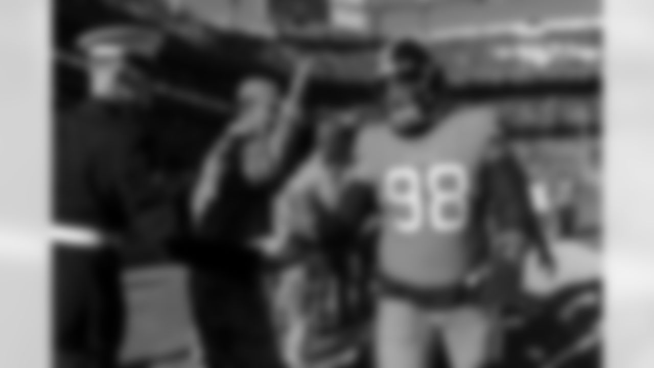 Mike Purcell high-fives military service members on his way off the field during warmups before the Broncos' Week 11 game against the Las Vegas Raiders at Empower Field at Mile High in Denver, Colorado on November 20, 2022. (Photo by Ben Swanson)