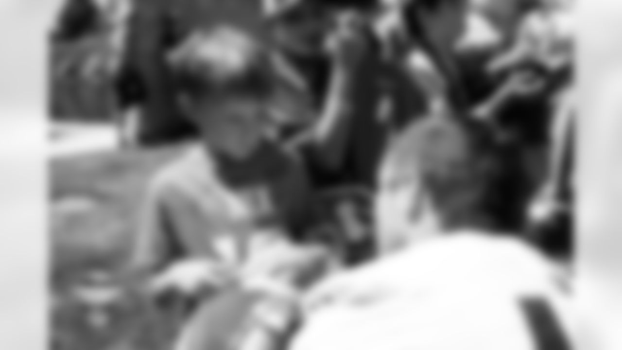 Nate Adkins signs autographs for fans during a training camp practice at Broncos Park Powered by CommonSpirit on July 26, 2025 in Englewood, Colorado. Photo by Ben Swanson / Denver Broncos