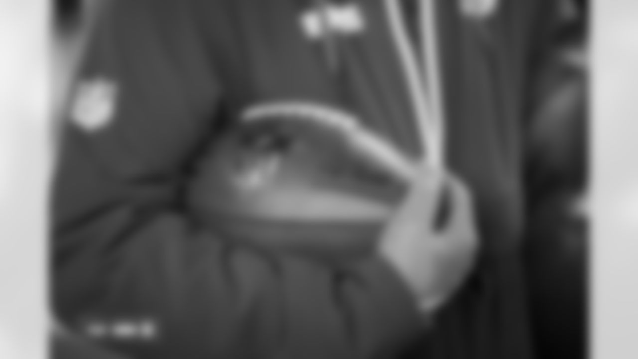 An equipment manager holds a football photographed on film during the Broncos' Week 10 game against the Las Vegas Raiders at Empower Field at Mile High in Denver, Colorado on November 7, 2025. Photo by Gabriel Christus / Denver Broncos