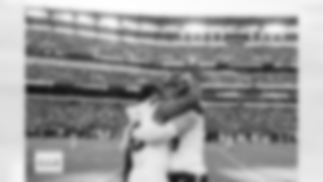 Denver Broncos linebacker Nik Bonitto (15) and defensive end Zach Allen (99) hug after the Broncos' Week 5 game against the Philadelphia Eagles at Lincoln Financial Field in Philadelphia, Pennsylvania on October 5, 2025. Photo by Gabriel Christus / Denver Broncos