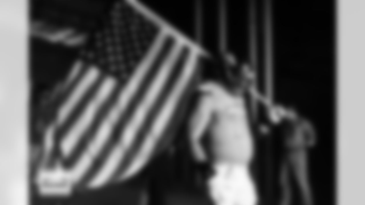 Denver Broncos offensive tackle Garett Bolles (72) holds an American flag in the tunnel for team introductions before the Broncos' Week 11 game against the Kansas City Chiefs at Empower Field at Mile High in Denver, Colorado on November 16, 2025. Photo by Gabriel Christus / Denver Broncos