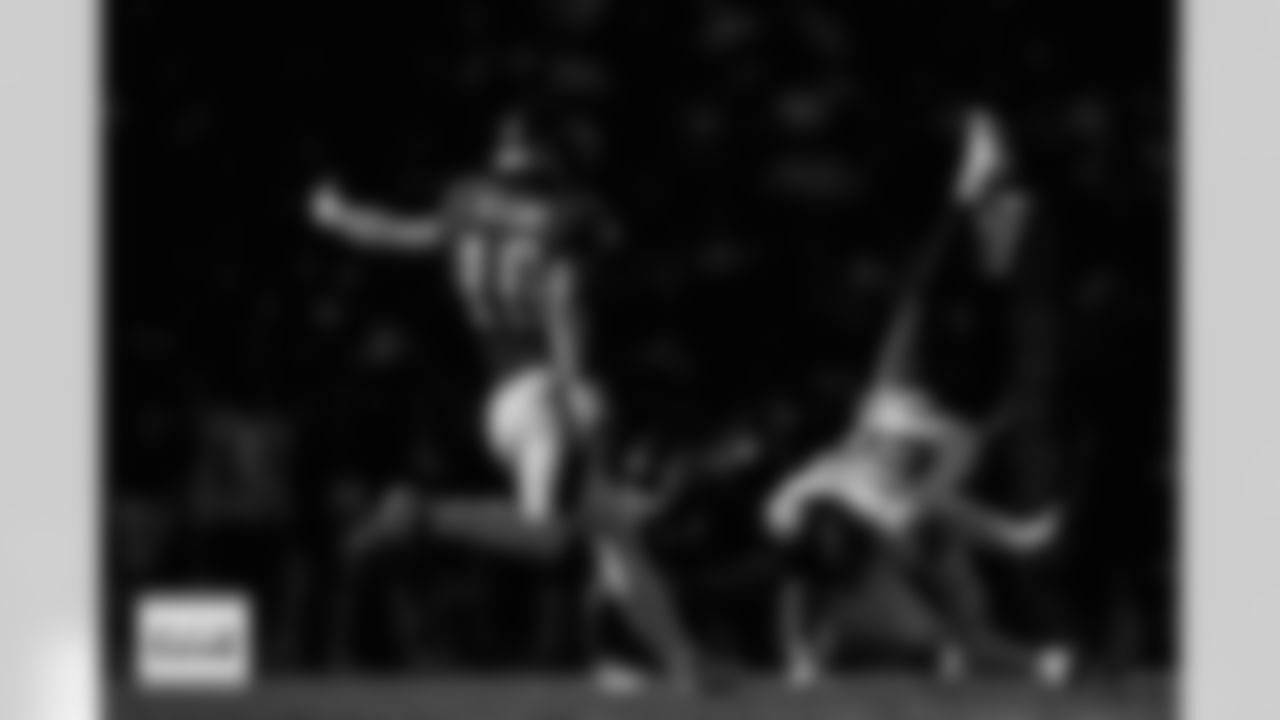 Denver Broncos linebacker Garret Wallow (50) gets knocked to the ground as Philadelphia Eagles punter Braden Mann (10) punts the ball during the Broncos' Week 5 game against the Philadelphia Eagles at Lincoln Financial Field in Philadelphia, Pennsylvania on October 5, 2025. Photo by Gabriel Christus / Denver Broncos