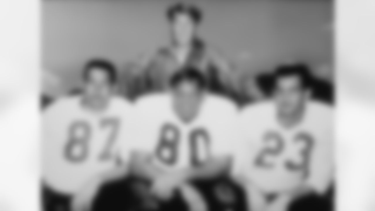 Frank Filchock with his all-league trio: end Lionel Taylor (87), defensive tackle Bud McFadin (80) and safety Austin "Goose" Gonsoulin (23).