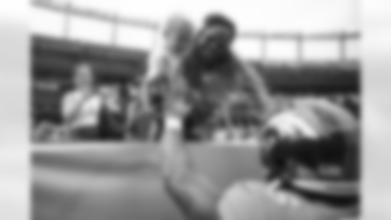 Samaje Perine greets his son before the Broncos' Week 1 game against the Las Vegas Raiders at Empower Field at Mile High in Denver, Colorado on September 10, 2023. Photo by Ben Swanson / Denver Broncos
