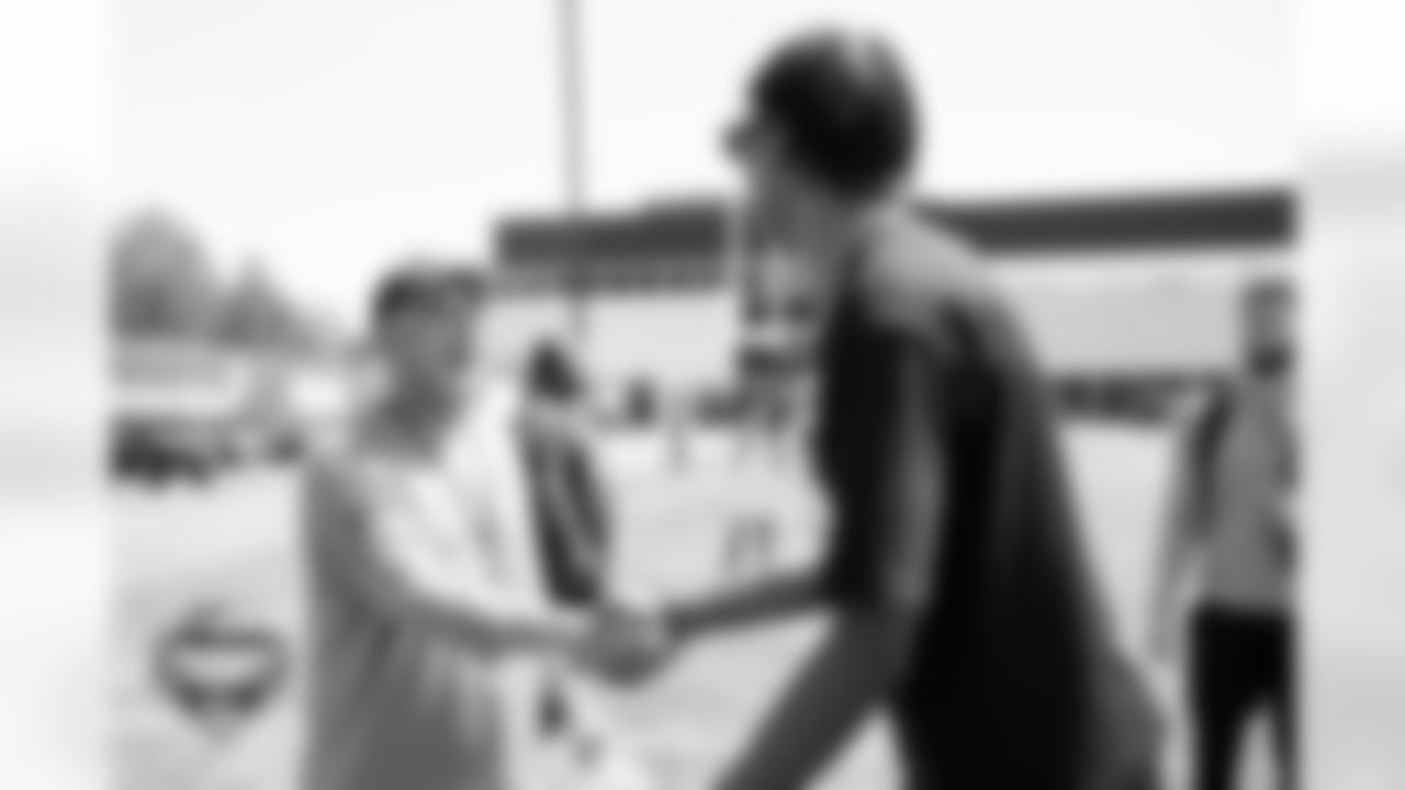 Sean Payton shakes hands with Denver Nuggets player Peyton Watson during a training camp practice at Broncos Park Powered by CommonSpirit on August 13, 2025 in Englewood, Colorado. Photo by Ben Swanson / Denver Broncos