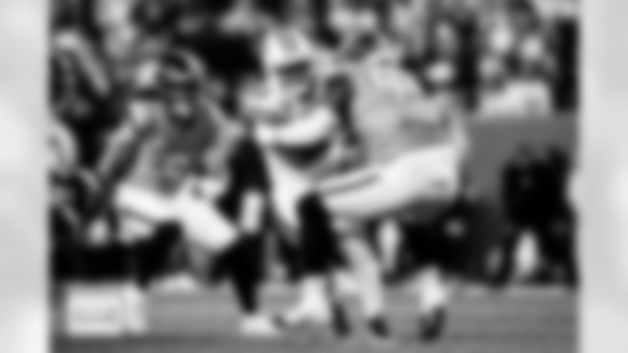 Denver Broncos defensive tackle Malcolm Roach (97) tackles Green Bay Packers running back Josh Jacobs (8) during the Broncos' Week 15 game against the Green Bay Packers at Empower Field at Mile High in Denver, Colorado on December 14, 2025. Photo by Ben Swanson / Denver Broncos