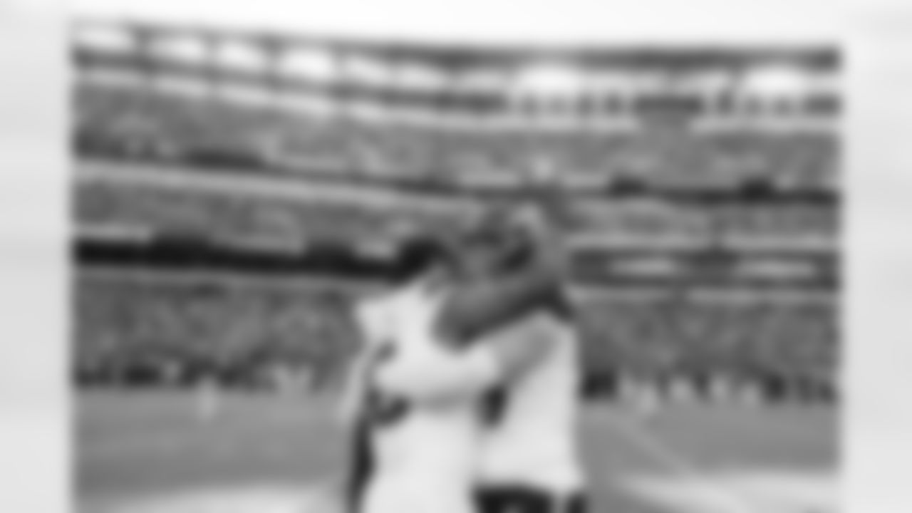 Denver Broncos linebacker Nik Bonitto (15) and defensive end Zach Allen (99) hug after the Broncos' Week 5 game against the Philadelphia Eagles at Lincoln Financial Field in Philadelphia, Pennsylvania on October 5, 2025. Photo by Gabriel Christus / Denver Broncos